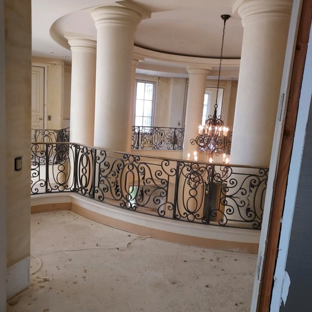 Custom wrought iron decorative interior railing with scroll design